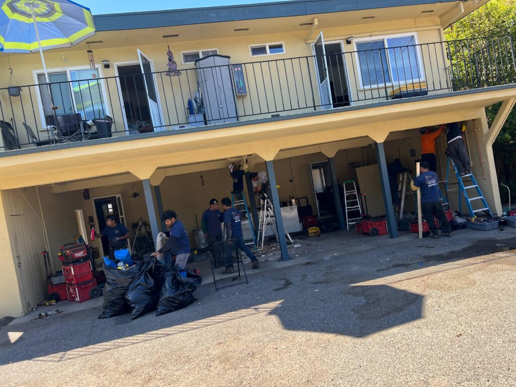 All Pro Repipes crew working on a repiping project at a multi-family HOA building, with technicians using ladders and tools to upgrade plumbing systems.
